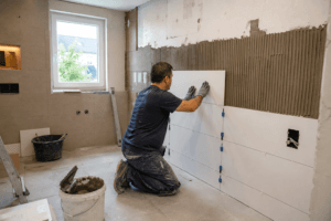 Fliesenleger verlegt großformatige Wandfliesen bei modernen Badsanierungen in Stuttgart im Badezimmer