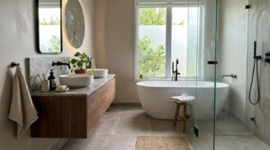Modern luxury bathroom with freestanding tub, floating vanity, and black fixtures – designed with Badplaner Online.